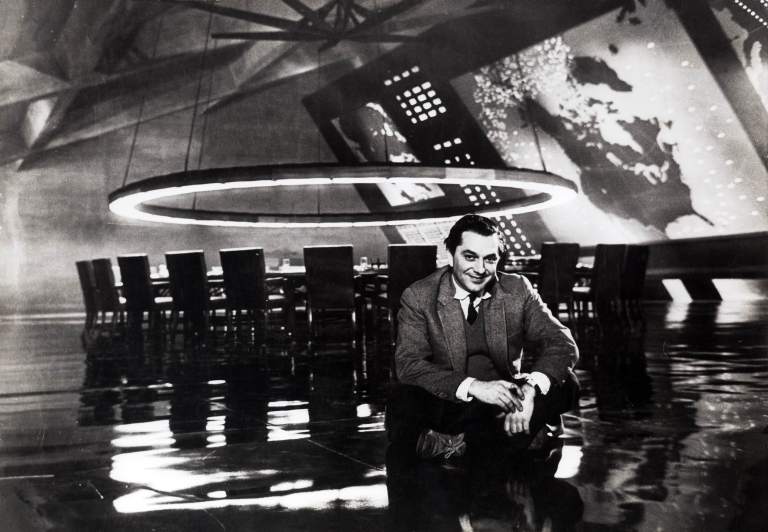 Ken Adam, 1963 Am Set des „War Room“ aus DR. STRANGELOVE OR: HOW I LEARNED TO STOP WORRYING AND LOVE THE BOMB GB/USA 1964, Regie: Stanley Kubrick Quelle: Deutsche Kinemathek – Ken Adam Archiv